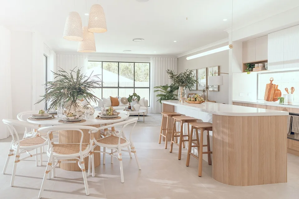 Coastal kitchen and dining with warm timber accents featured in our display home